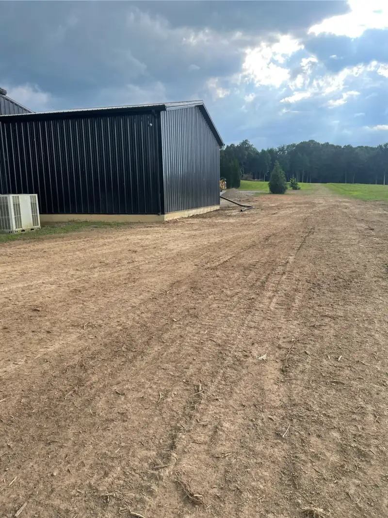The same barn with the cedars cleared away and the ground alongside graded flat